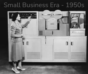 Black and white image of a woman in front of a 1950's computer.